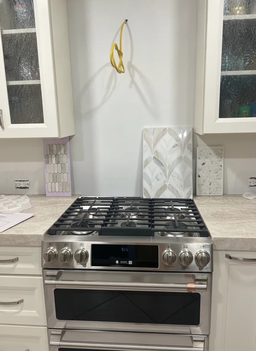 The same honey oak kitchen with cabinets repainted creamy warm white, counters and stainless range unchanged